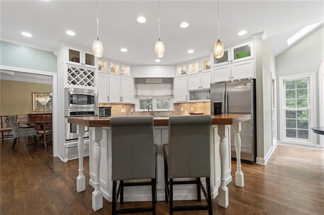4575 Dairy Way, Peachtree Corners, GA 30092 - kitchen with appliances with stainless steel finishes, backsplash, decorative light fixtures, a kitchen bar, and recessed lighting