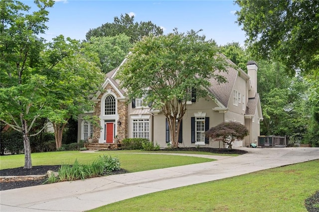4575 Dairy Way, Peachtree Corners, GA 30092 - view of front of property featuring a chimney, a front lawn, stucco siding, stone siding, and driveway
