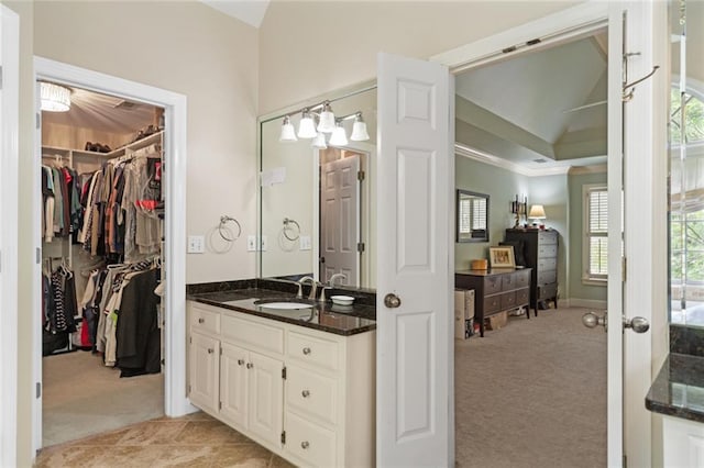 4575 Dairy Way, Peachtree Corners, GA 30092 - bathroom with vanity, ornamental molding, a walk in closet, and baseboards
