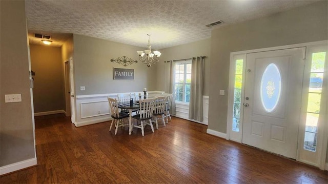 116 Ridge Xing, Temple, GA 30179 - dining space with a notable chandelier, visible vents, and wood finished floors