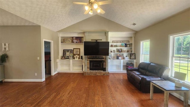 116 Ridge Xing, Temple, GA 30179 - living area featuring visible vents, a brick fireplace, a ceiling fan, wood finished floors, and vaulted ceiling