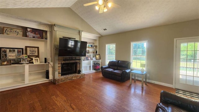 116 Ridge Xing, Temple, GA 30179 - living area with baseboards, vaulted ceiling, a brick fireplace, ceiling fan, and wood finished floors