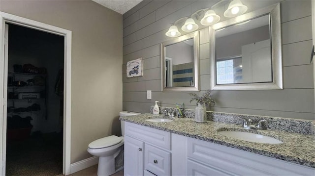 116 Ridge Xing, Temple, GA 30179 - full bathroom featuring a sink, a walk in closet, toilet, and double vanity