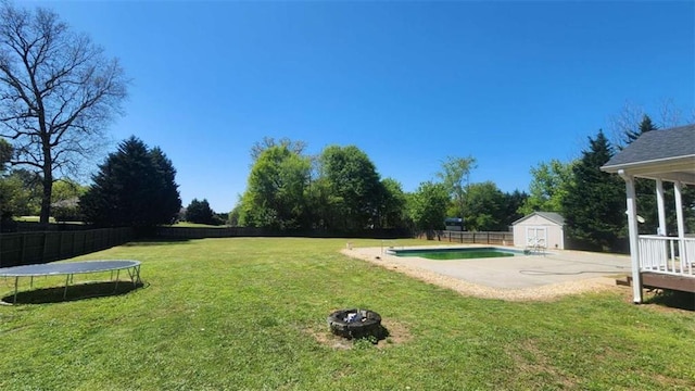 116 Ridge Xing, Temple, GA 30179 - view of yard with a fire pit, a shed, a trampoline, a fenced backyard, and an outbuilding