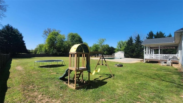 116 Ridge Xing, Temple, GA 30179 - view of yard featuring a trampoline, a patio, an outdoor structure, a fenced backyard, and a playground