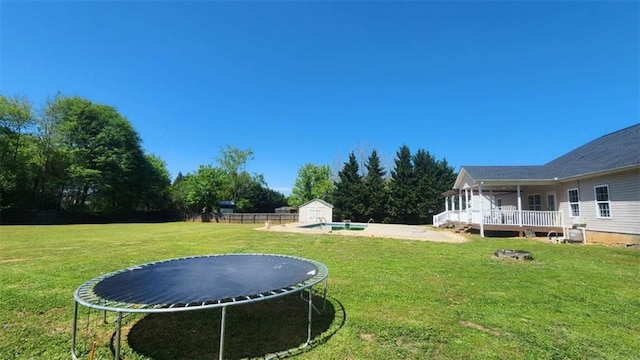 116 Ridge Xing, Temple, GA 30179 - view of yard with an outbuilding, a storage shed, a sunroom, a trampoline, and a fenced in pool