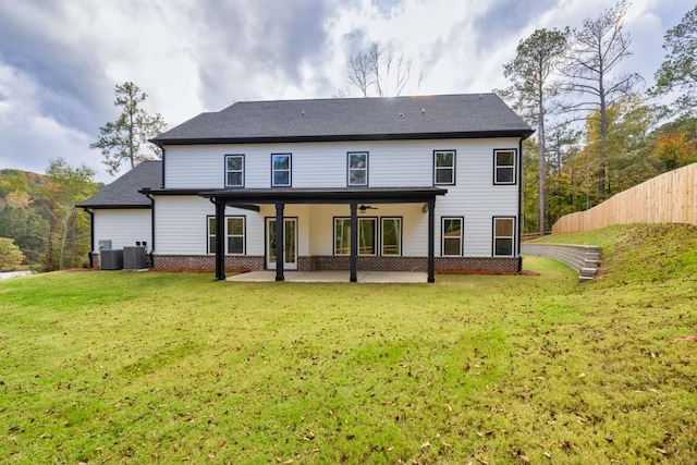 back of house with central AC, a patio, and a yard