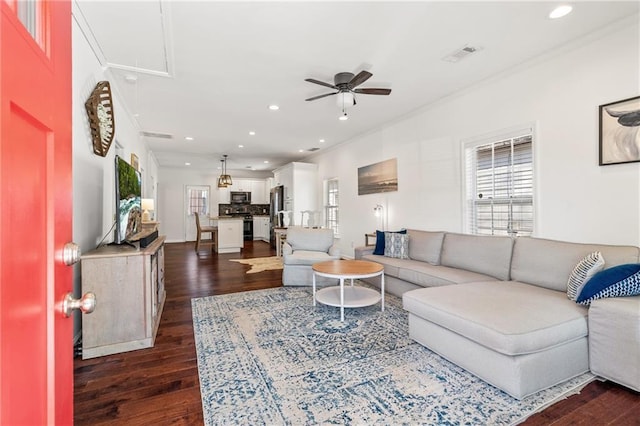 living area with dark wood-style floors, attic access, visible vents, and recessed lighting