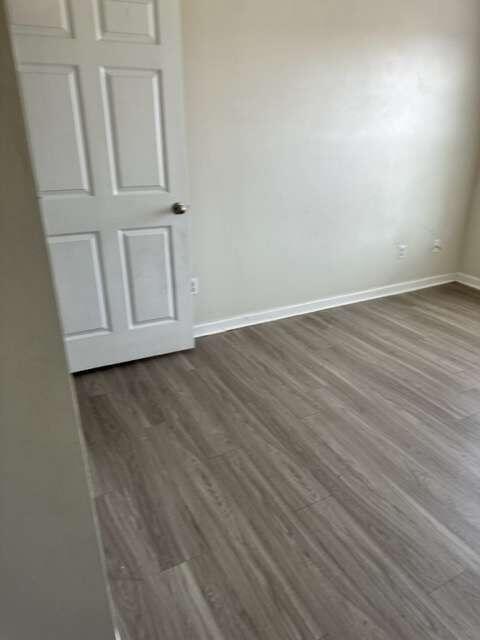 unfurnished room featuring dark hardwood / wood-style floors