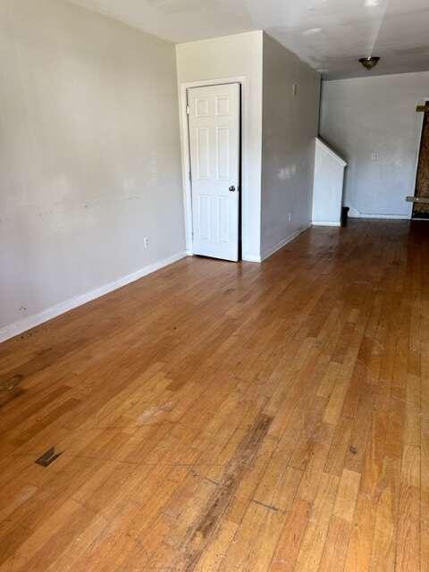 empty room with hardwood / wood-style floors