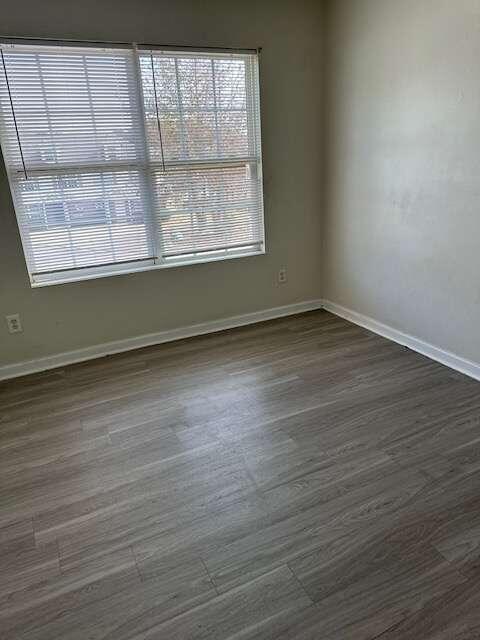 empty room with dark wood-type flooring