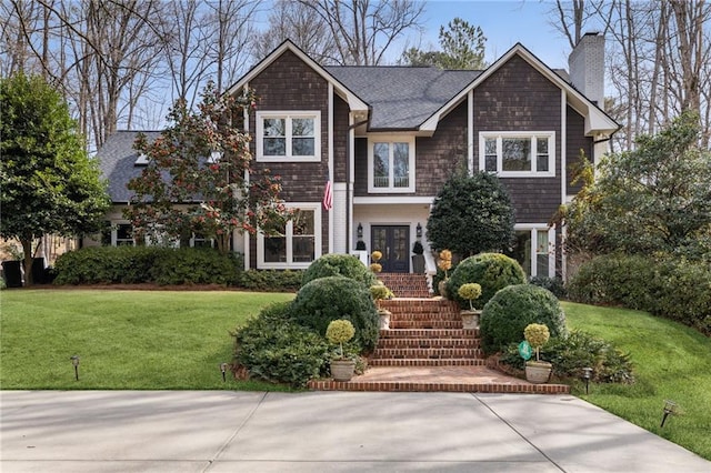 view of front of property featuring a front yard, french doors, and a chimney