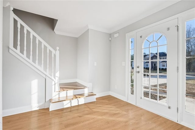 interior space featuring wood-type flooring and ornamental molding