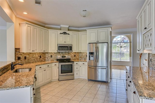 kitchen featuring appliances with stainless steel finishes, a sink, ornamental molding, light tile patterned flooring, and light stone counters