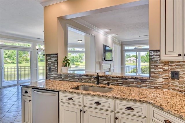 kitchen featuring dishwasher, a sink, crown molding, backsplash, and light stone counters