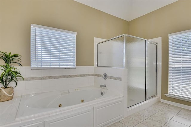 full bathroom featuring a stall shower, a jetted tub, and tile patterned flooring