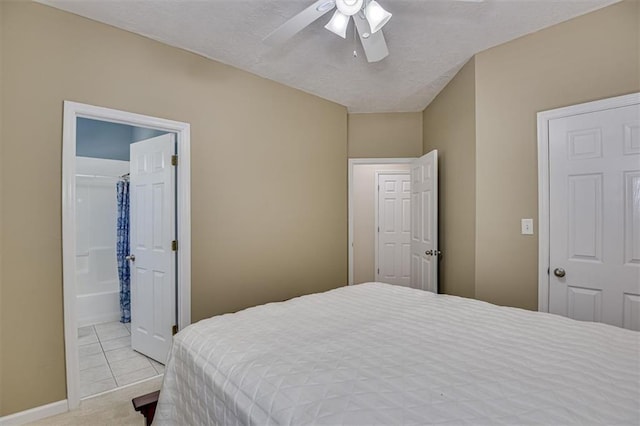 carpeted bedroom with a ceiling fan, tile patterned floors, and baseboards