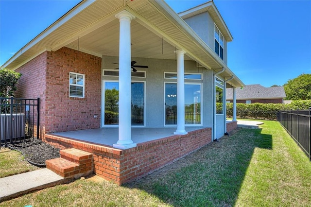 back of house with a patio area, central AC, stucco siding, brick siding, and ceiling fan