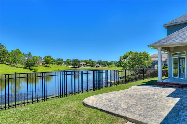 view of yard with a water view and a patio area