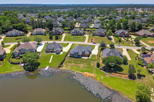 aerial view of property's location with nearby suburban area and a large body of water