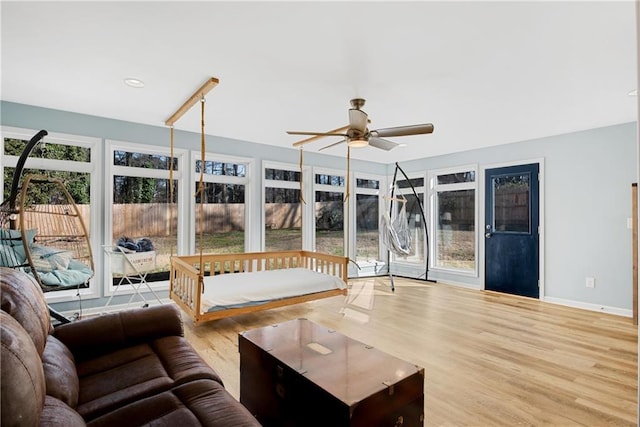 living room with ceiling fan and light hardwood / wood-style flooring