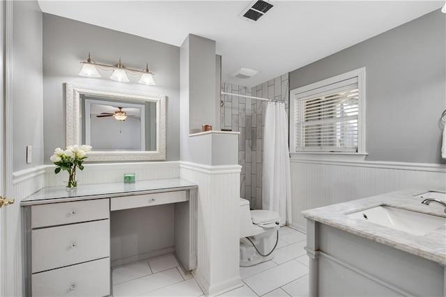 bathroom with tile patterned flooring, vanity, curtained shower, and toilet