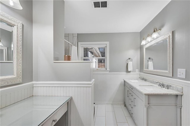 bathroom with vanity and tile patterned flooring