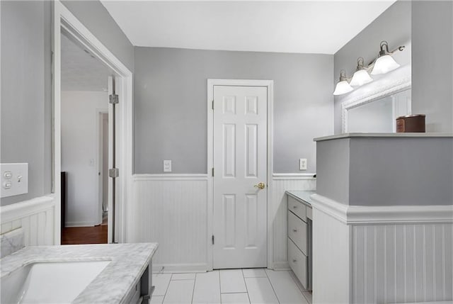 bathroom with tile patterned floors and vanity