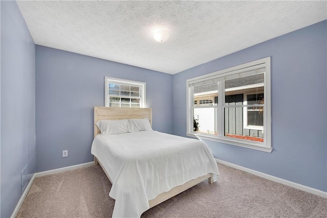 carpeted bedroom with a textured ceiling