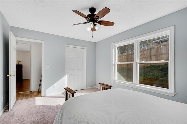 bedroom with light colored carpet and ceiling fan