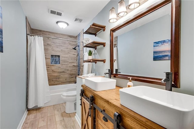 full bathroom with shower / tub combo, vanity, wood-type flooring, and toilet