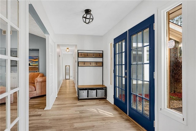 mudroom featuring light wood-type flooring and french doors