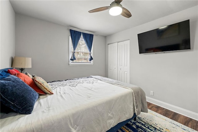 bedroom with a ceiling fan, a closet, baseboards, and wood finished floors