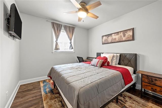 bedroom with a ceiling fan, baseboards, and wood finished floors