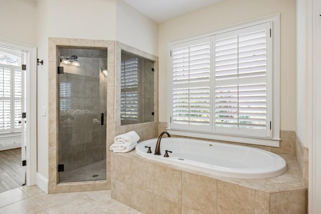 full bath featuring a shower stall, a bath, and tile patterned floors