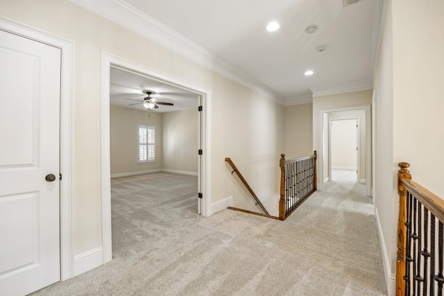 hallway featuring ornamental molding, carpet flooring, an upstairs landing, and baseboards