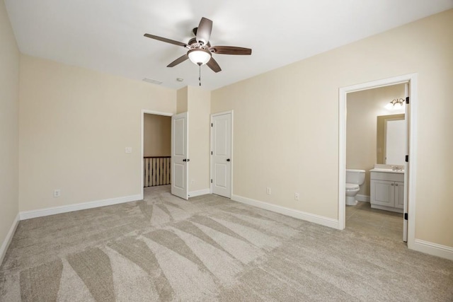 unfurnished bedroom featuring visible vents, baseboards, connected bathroom, and light colored carpet