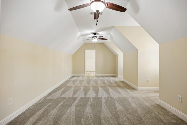 bonus room with light carpet, baseboards, and vaulted ceiling