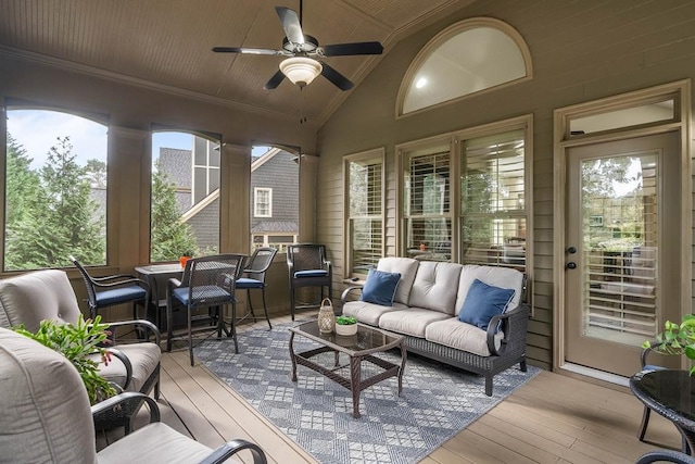 sunroom with lofted ceiling, wooden ceiling, and ceiling fan