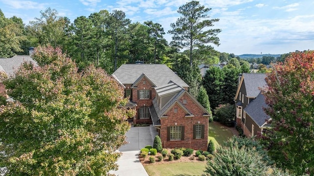 view of front facade featuring driveway and brick siding