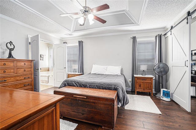 bedroom with dark wood-style floors, a barn door, a textured ceiling, and crown molding