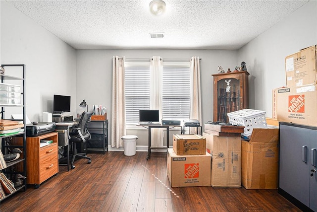 office area with visible vents, dark wood finished floors, and a textured ceiling