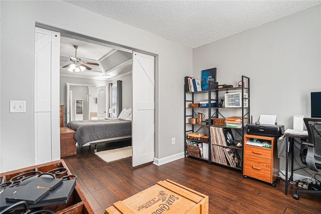 bedroom featuring a textured ceiling, ceiling fan, wood-type flooring, and baseboards