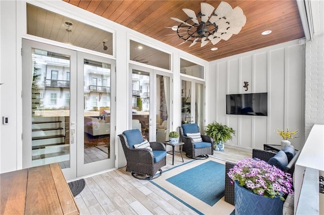 sunroom / solarium featuring french doors and wood ceiling