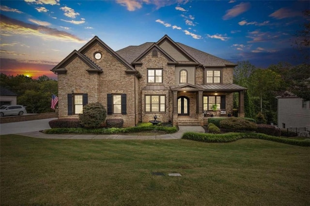 view of front of property featuring a lawn and a porch