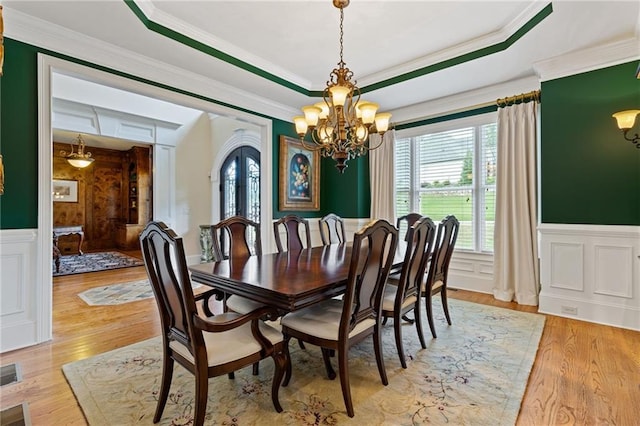 dining room featuring ornamental molding and light wood-type flooring