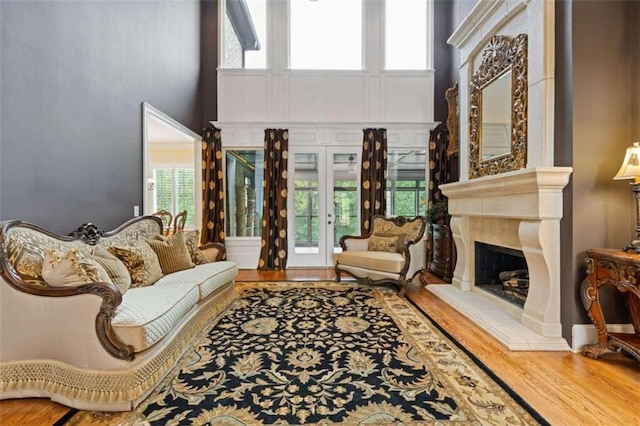 living room with a towering ceiling and hardwood / wood-style flooring