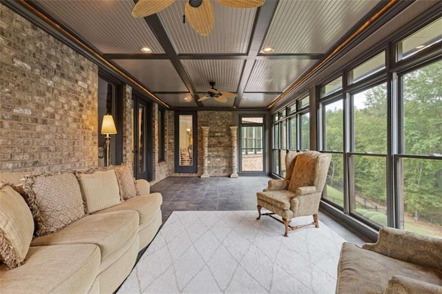 sunroom featuring ceiling fan