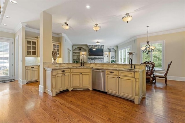 kitchen with a notable chandelier, dishwasher, light hardwood / wood-style floors, and a healthy amount of sunlight