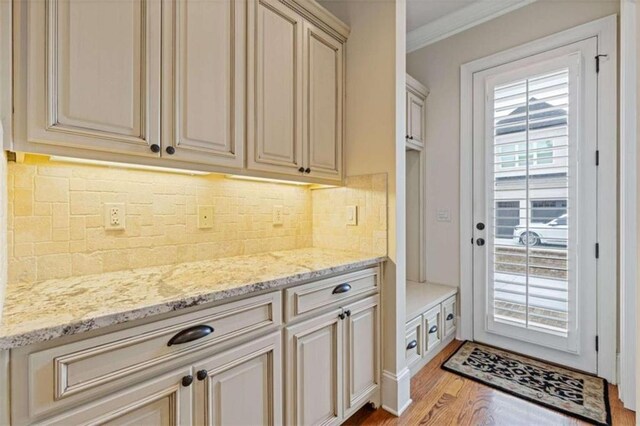 interior space with crown molding and light hardwood / wood-style flooring